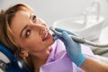 Pretty woman under a tooth polishing procedure