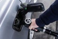Hand holding diesel nozzle for car refueling at gas station Royalty Free Stock Photo