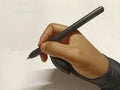 hand holding a digital drawing pen and wearing drawing gloves Royalty Free Stock Photo