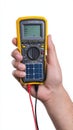Hand holding a digital multimeter for testing Royalty Free Stock Photo