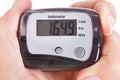 Hand holding digital pedometer Royalty Free Stock Photo