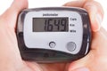 Hand holding digital pedometer