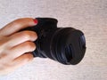 Hand holding a digital slr camera Royalty Free Stock Photo