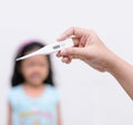 Hand holding digital thermometer for fever measurement with blur Royalty Free Stock Photo