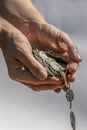 A Hand Holding and Dropping Coins