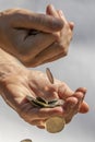 A Hand Holding and Dropping Coins Royalty Free Stock Photo