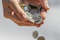 A Hand Holding and Dropping Coins Royalty Free Stock Photo