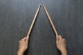 Hand holding drum stick on black table background Royalty Free Stock Photo