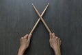 Hand holding drum stick on black table background Royalty Free Stock Photo