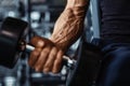 Hand holding dumbbell.Close up.Muscular arm in the gym. Royalty Free Stock Photo