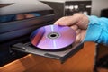 Hand holding DVD inserting to video player Royalty Free Stock Photo