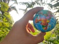 Hand holding earth globe with sunrise and nature Royalty Free Stock Photo