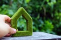 Hand holding eco house icon in nature Royalty Free Stock Photo
