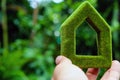 Hand holding eco house icon in nature Royalty Free Stock Photo