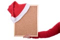 Hand holding empty frame with red santa hat Royalty Free Stock Photo