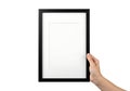 A hand holding an empty framed picture against a white background Royalty Free Stock Photo