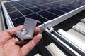 Hand Holding End Clamp of Solar PV Panel with How to Use on Background Royalty Free Stock Photo