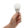 Hand holding energy efficient light bulb. Isolated on white background with clipping path Royalty Free Stock Photo