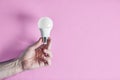 Hand holding energy efficient light bulb Royalty Free Stock Photo