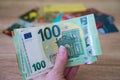 Hand holding euro money cash on many credit cards background, closeup Royalty Free Stock Photo