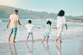 Hand holding, family is walking on beach and back view with ocean waves, summer and bonding in nature. Parents, children Royalty Free Stock Photo