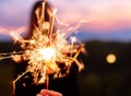 hand holding fire sparkles to celebrate the 4th of July Royalty Free Stock Photo