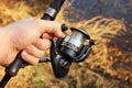 Hand Holding Fishing Pole And Fishing Reel Royalty Free Stock Photo