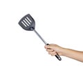 Hand holding flipper frying isolated on white background Royalty Free Stock Photo