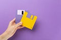 Hand holding floppy disk on color background, technology concept Royalty Free Stock Photo