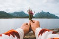 Hand holding flowers foggy mountains landscape Travel lifestyle vacations