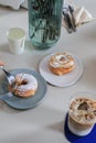 Hand holding foÃ Â¸Å¾k eating various donut on blue table. Sweet summer dessert. Party food