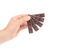Hand holding foiled dark chocolate bars.