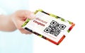 hand holding food discount coupon with qr code isolated over white