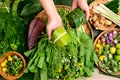 Hand holding food wrapped by banana leaf and Asian vegetables