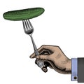 Hand holding a fork with a cucumber