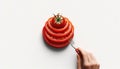 A hand holding a fork over a stack of tomato slices Royalty Free Stock Photo