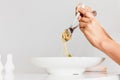 Hand holding fork and spoon eating spaghetti truffle cream sauce. Royalty Free Stock Photo