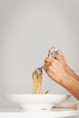 Hand holding fork and spoon eating spaghetti truffle cream sauce. Royalty Free Stock Photo