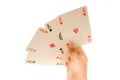 Hand holding four aces