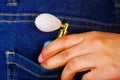 Hand holding a fragance inside of jeans back pocket Royalty Free Stock Photo