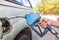 Hand holding fuel nozzle refueling gas pump for the car Royalty Free Stock Photo