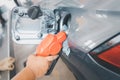 Hand holding fuel pump nozzle service refuel gas station. oil power energy automobile transport Royalty Free Stock Photo