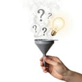 Hand holding funnel with light bulb and question marks Royalty Free Stock Photo