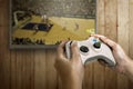 Hand holding game console controller playing game