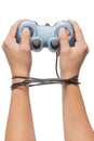 Hand holding game controller and tied up with cables isolated on Royalty Free Stock Photo