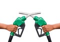 Hand holding gas nozzle with one last drop. A man holding a green gasoline nozzle on a white background. Royalty Free Stock Photo