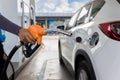 Hand holding gas nozzle with one last drop. A man holding a gasoline nozzle. Hands of men who were holding an automatic nozzle to Royalty Free Stock Photo