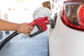 Hand holding gas nozzle with one last drop. A man holding a gasoline nozzle. Hands of men who were holding an automatic nozzle to Royalty Free Stock Photo