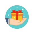 Hand holding gift box decorated with a red bow on isolated white background. EPS 10 vector Royalty Free Stock Photo