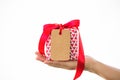 Hand holding a gift box on white background. Holidays, present, Royalty Free Stock Photo